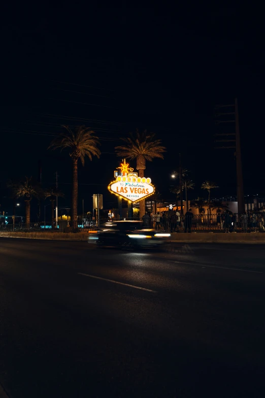 a street with an old time sign and lights at night