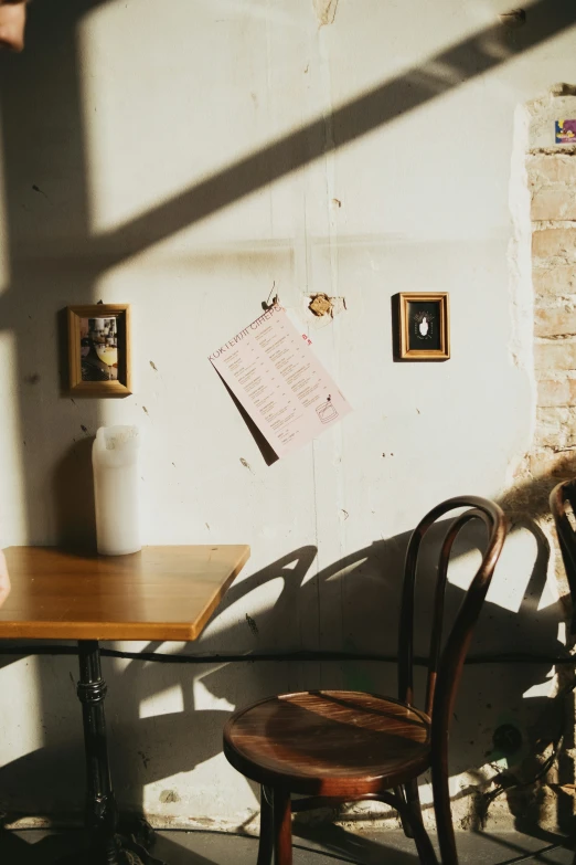 an image of a light from the window on a table and chair