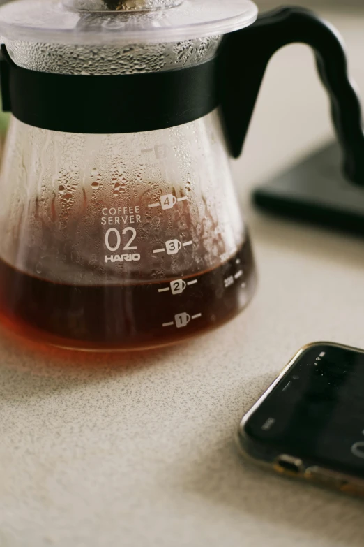 an apple sits next to a tea pot