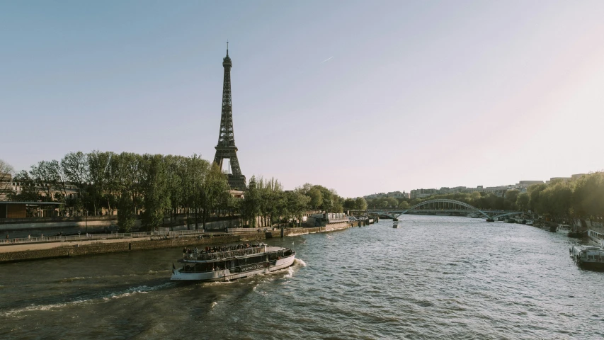 a boat floats down a river near the eiffel tower