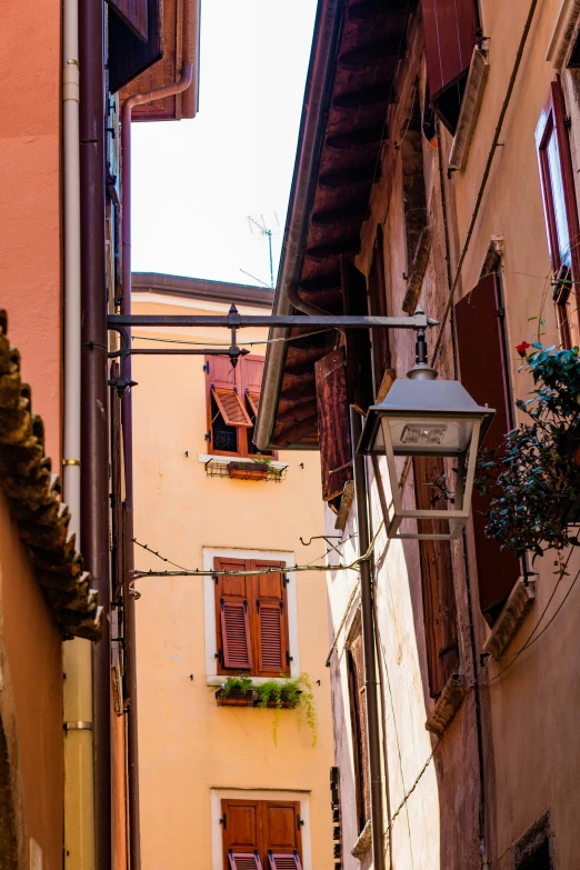 an image of old style windows on a narrow alley