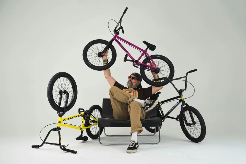 a man sits in a chair with his bicycle attached to it