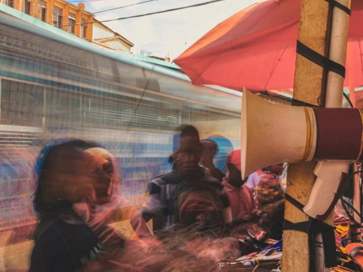 people standing in line by the side of a train