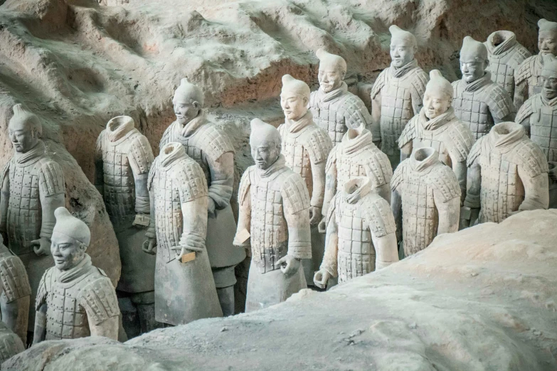 rows of statues of men in winter clothes