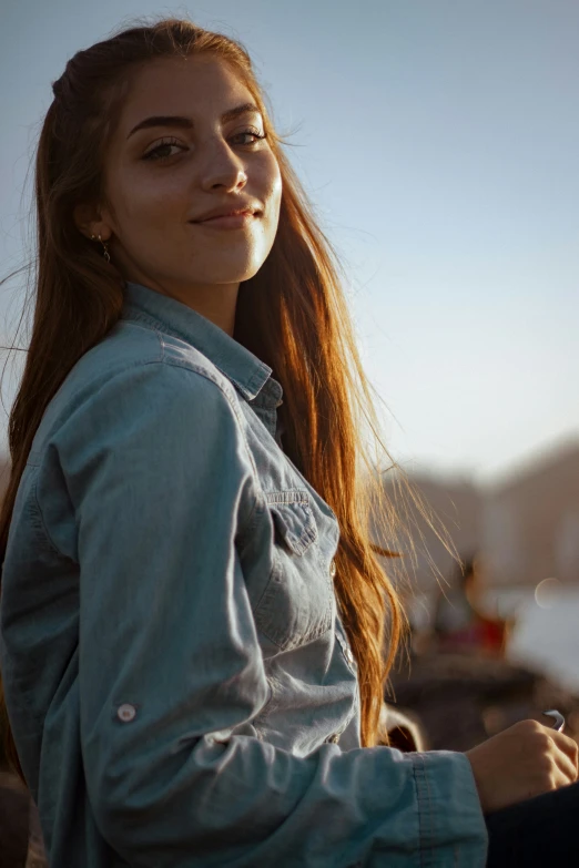 a girl standing with her eyes closed and holding a phone