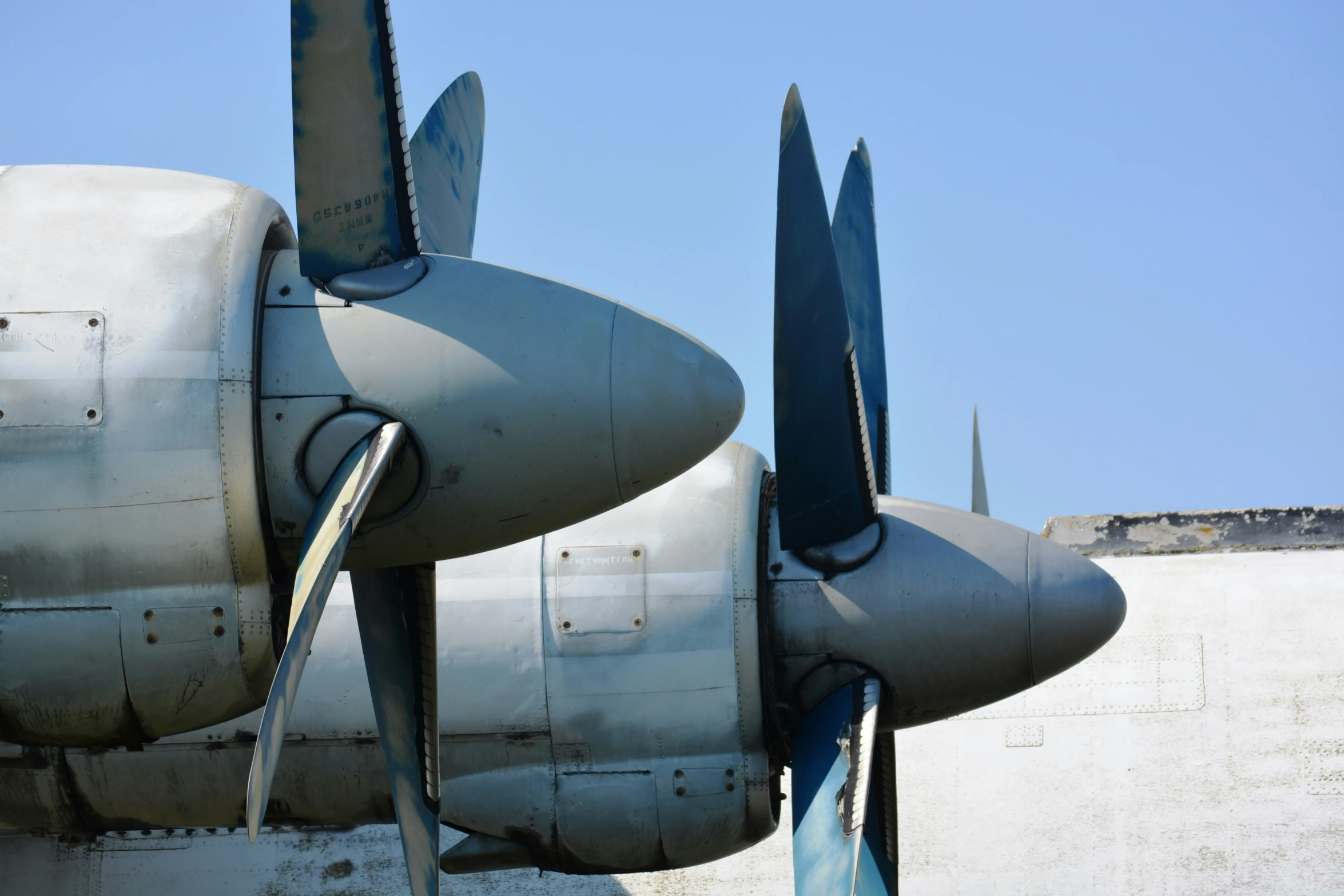 the underside of a fighter plane with propellors on each wings