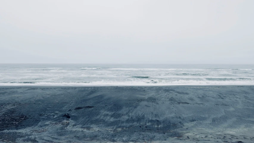 a view of an ocean with waves crashing on the shore