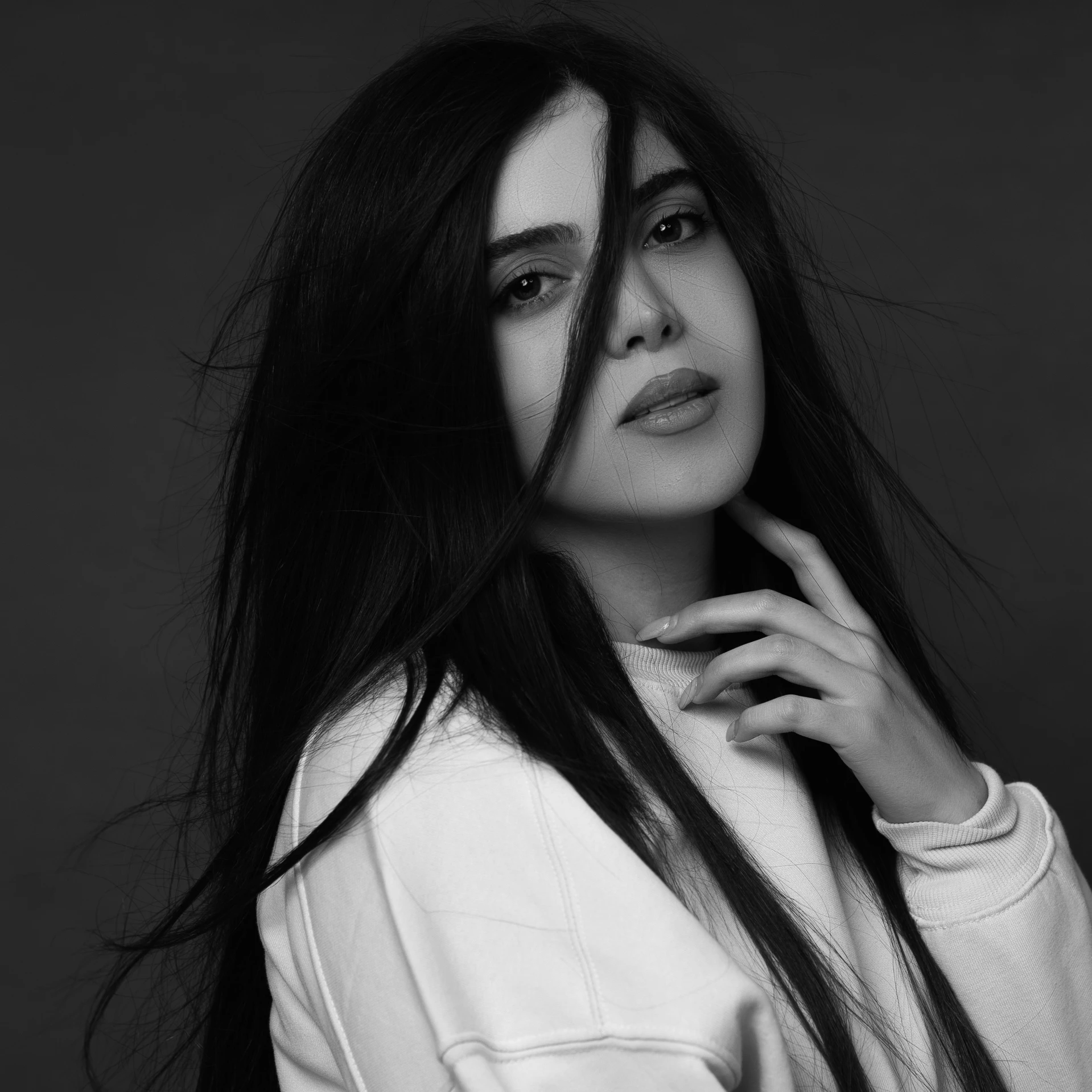 a woman with long hair posing for a black and white pograph