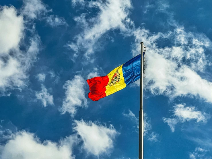 a flag is flying against a blue sky