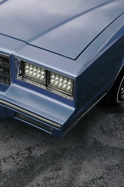 the front grille and side lights of a blue pontiac