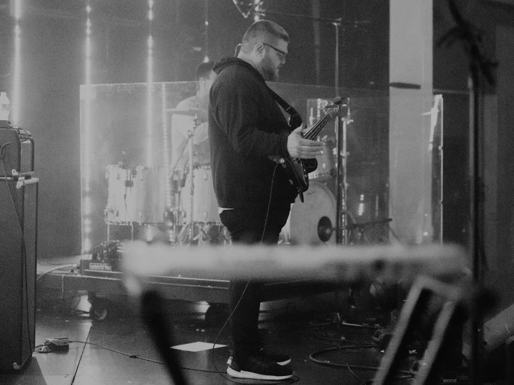 a man is on stage with his guitar