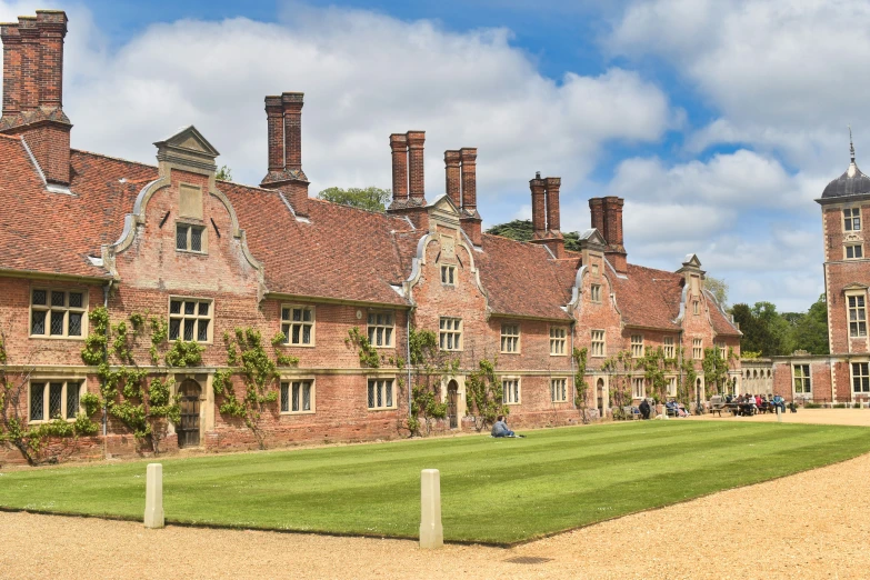 a large brick building with multiple chimneys is shown