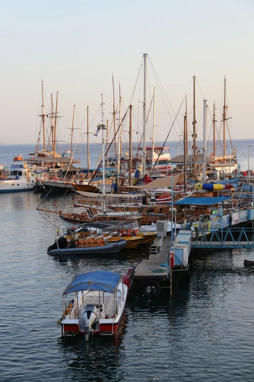 many boats parked in a bay and a man is taking a picture