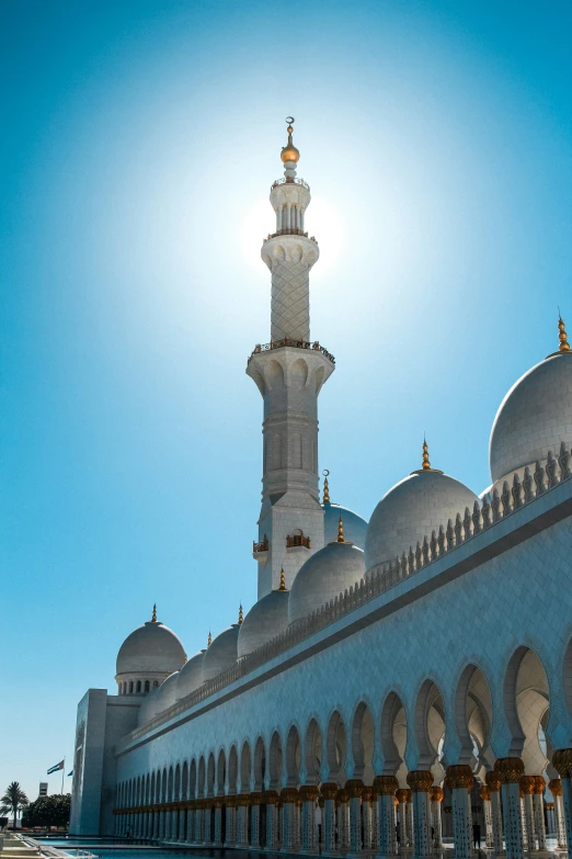 a large white building sitting under a blue sky