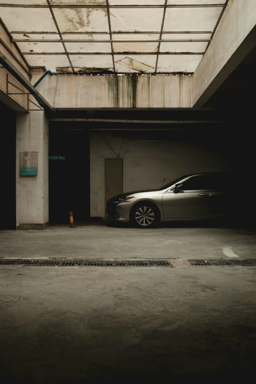 the parked car is in an empty parking garage