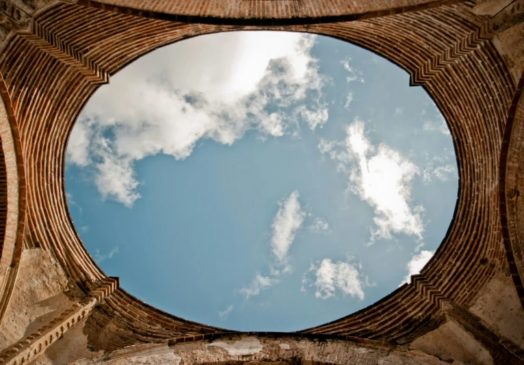 the round window of an old building is covered in bricks