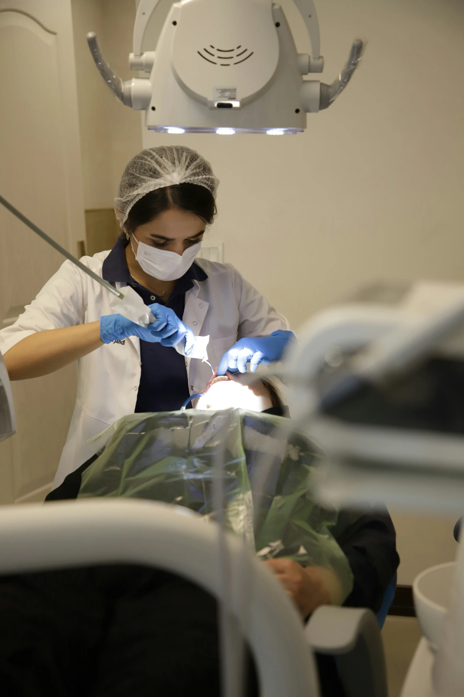 a woman in a medical mask has surgical equipment