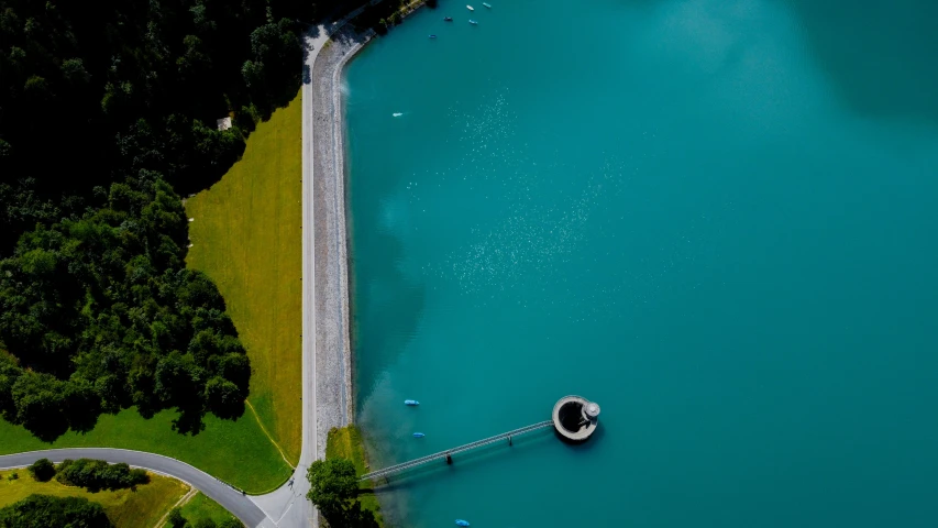 a boat tied to the dock next to a road