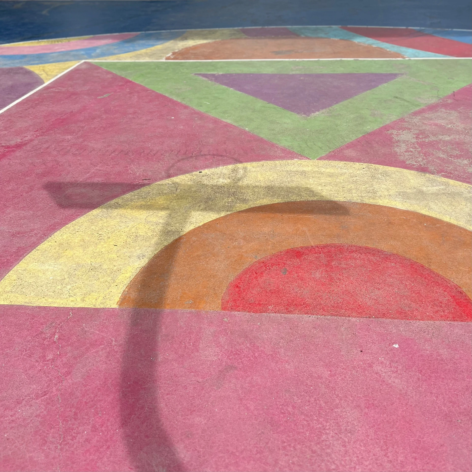 a circle painted with bright colors on a concrete floor