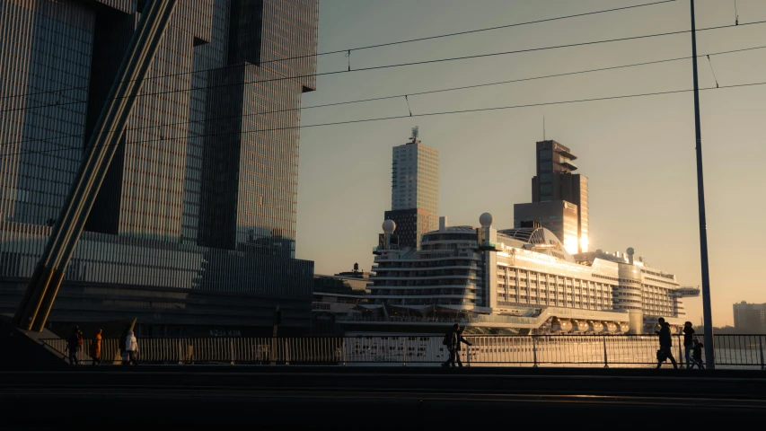 a large white ship next to a couple of tall buildings