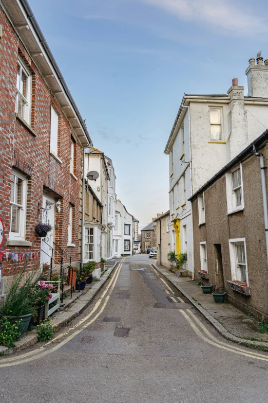 a paved alley with some old buildings on either side