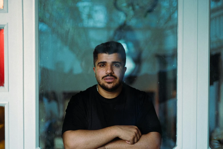 a man is standing in front of a glass door