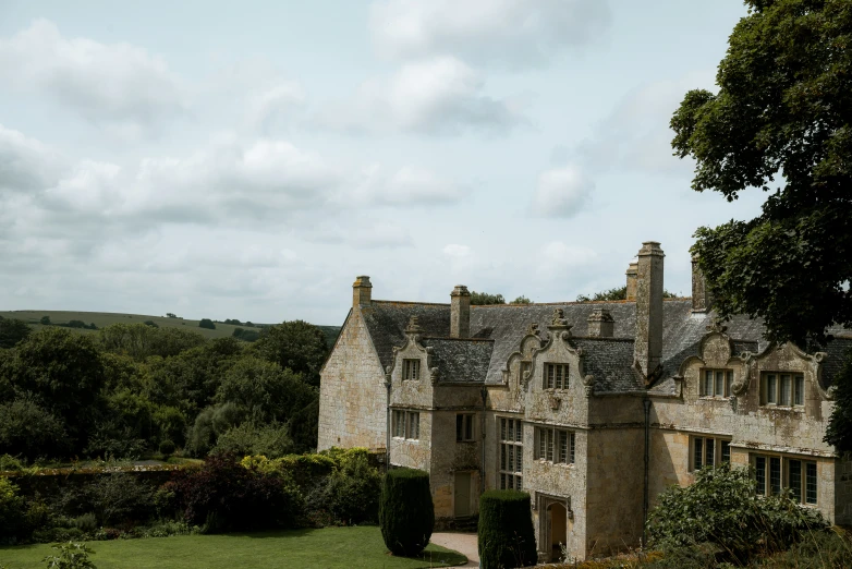 a large stone building with three stories in the middle of trees