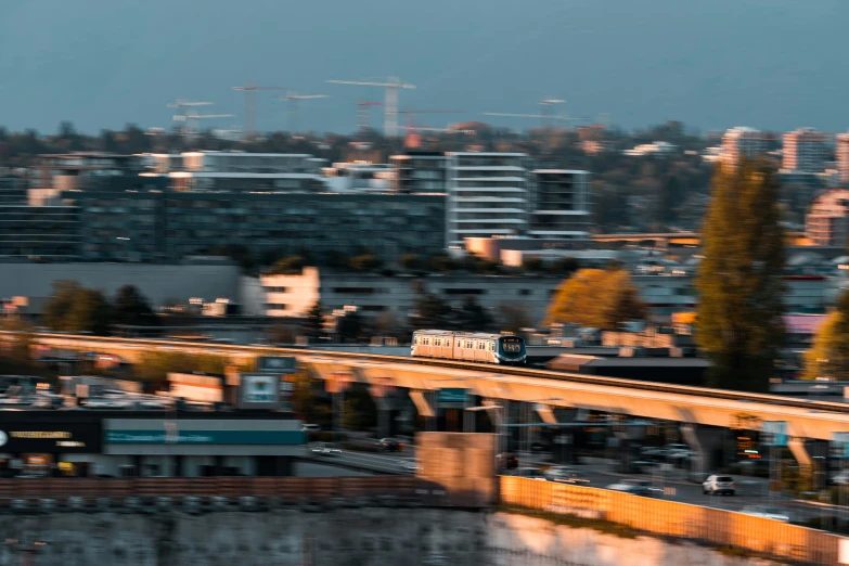 a train riding across a bridge spanning a city