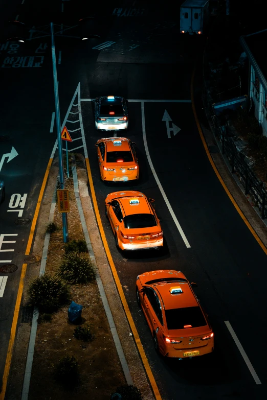 taxis are parked on the side of the street at night