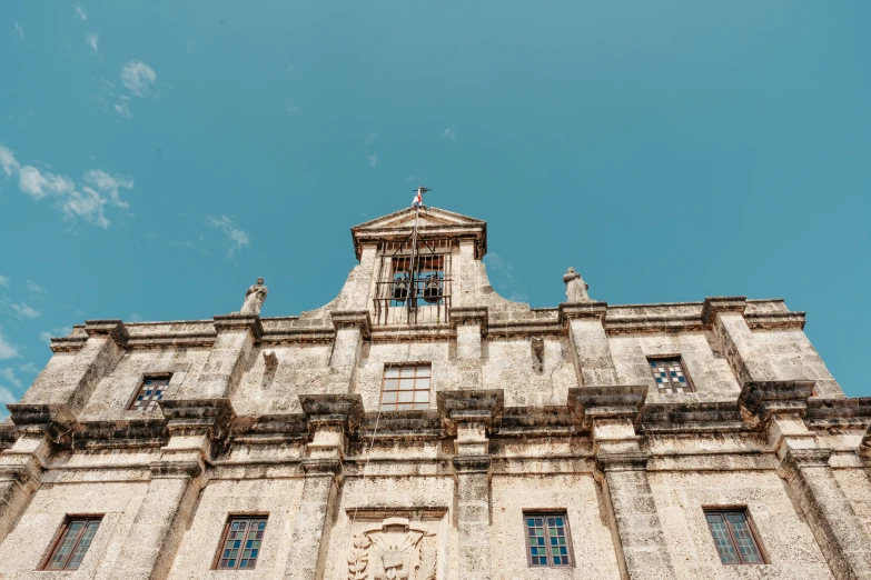 a white and black stone building with a clock