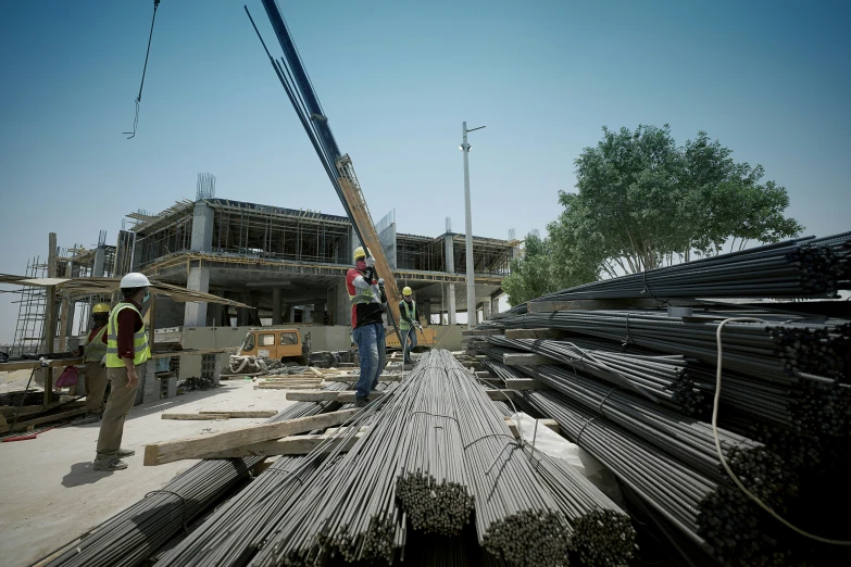 two men standing outside of a building under construction