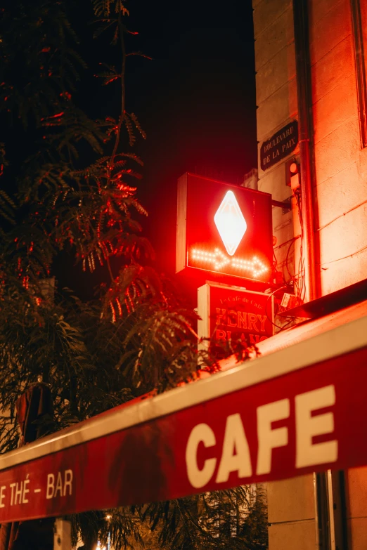 the red stop sign is displayed above a cafe