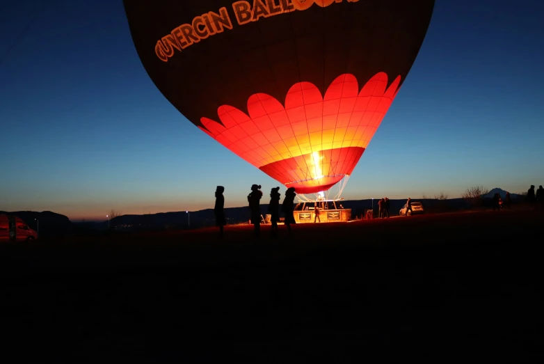 a group of people in a  air balloon at night