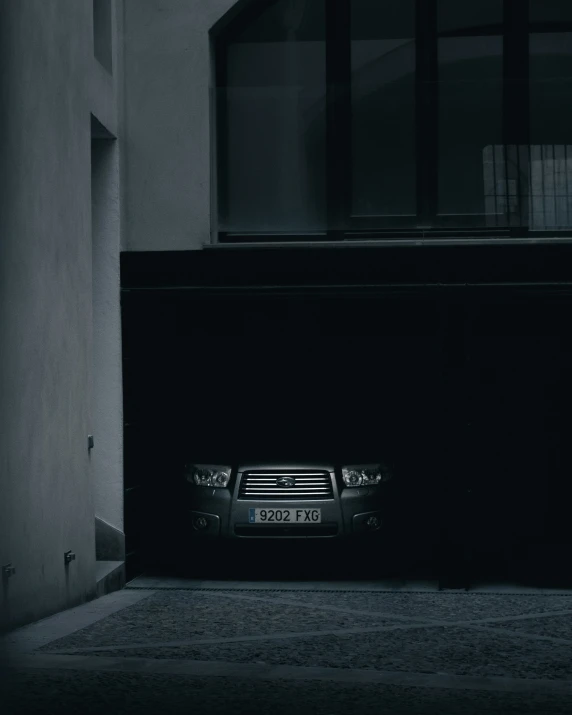 a car in front of a door that is black and white