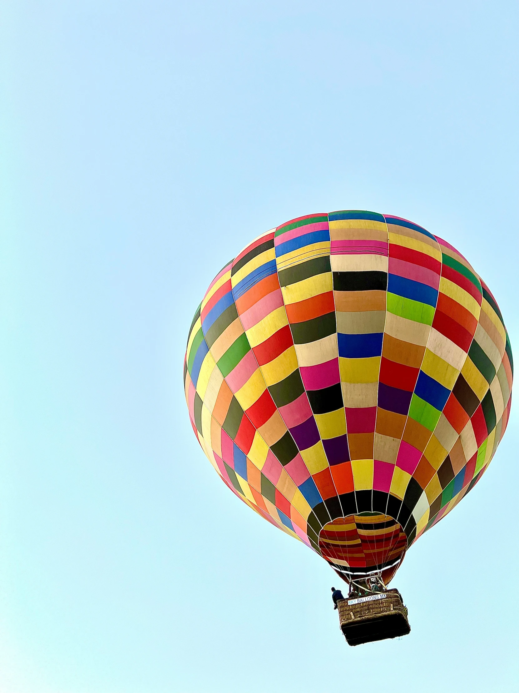 a colorful  air balloon flies through the sky