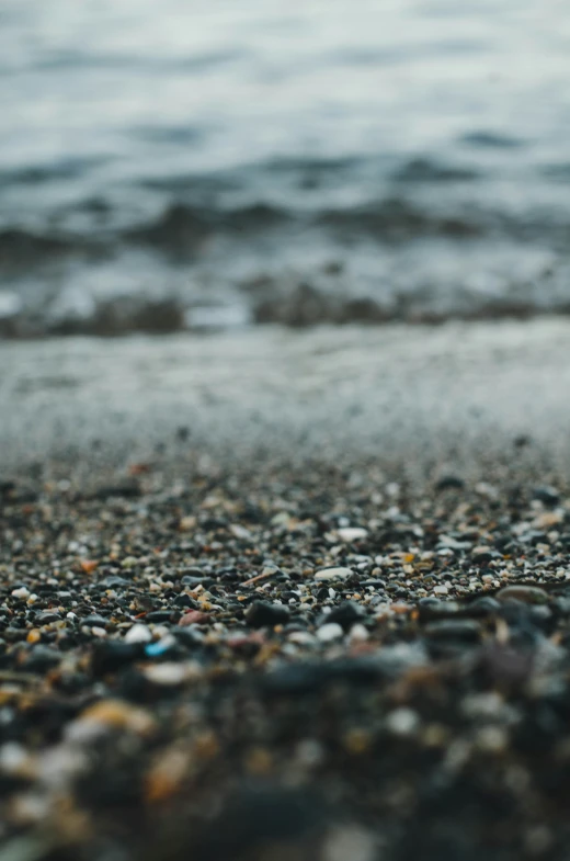 a little blue object is seen in the sand by the water