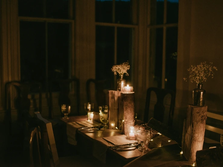 there is a dining room set up with candles