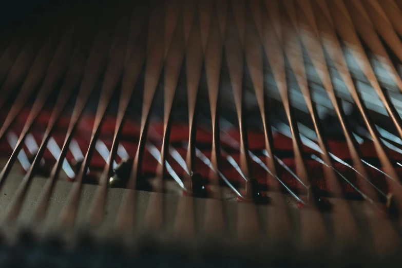 close up of a piano strings, with red pieces