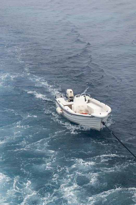 a small boat sits in choppy water