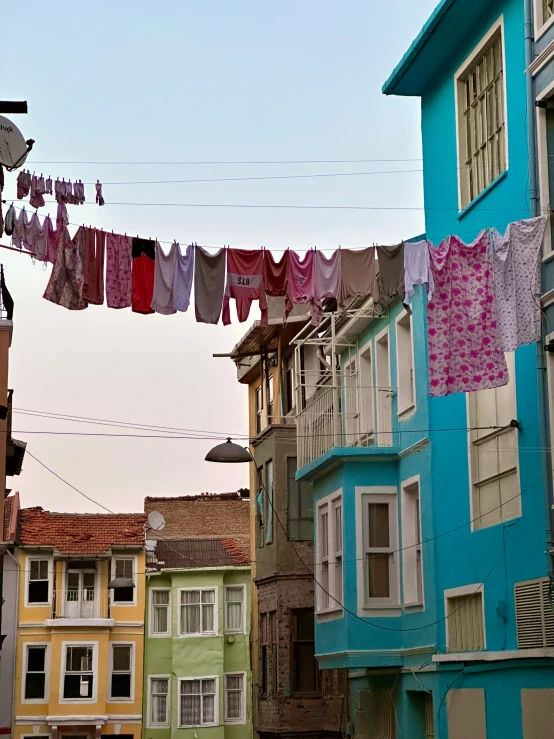 some laundry hangs over the streets in a colorful city