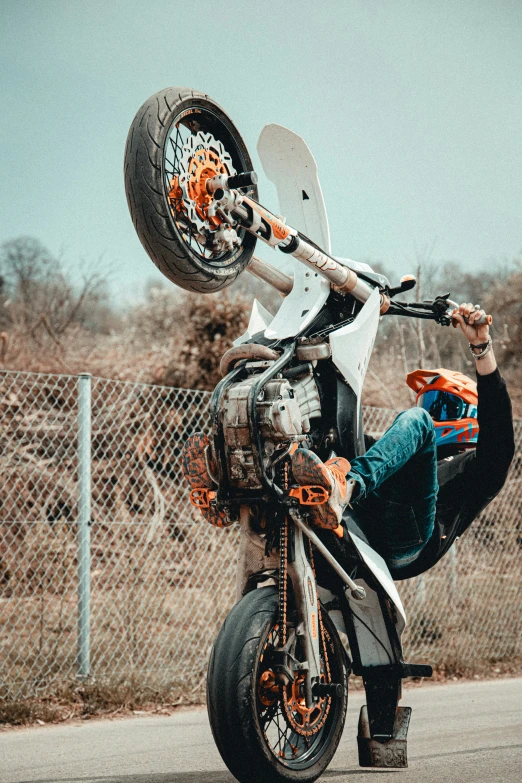 a person is upside down on a motorcycle with an electric scooter on the back of it