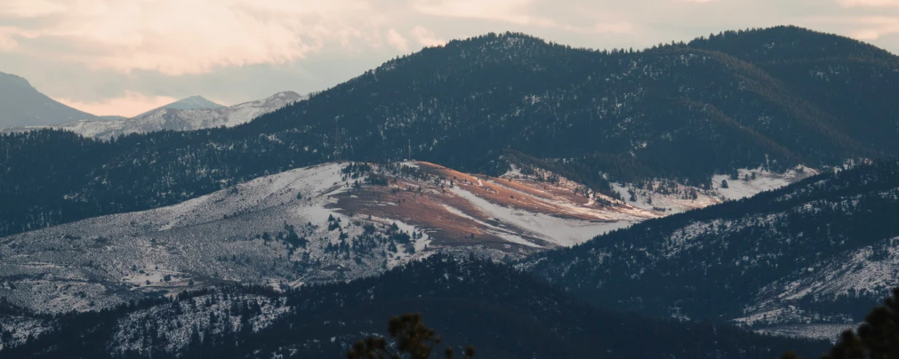 mountains with a cloudy sky in the background