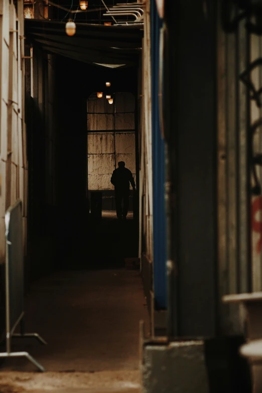 a man is sitting on a bench in the dark