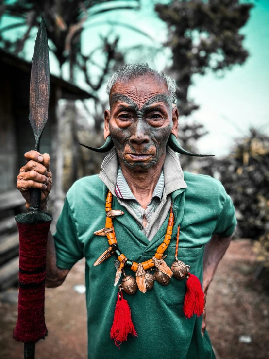 man with painted face holding up two knives