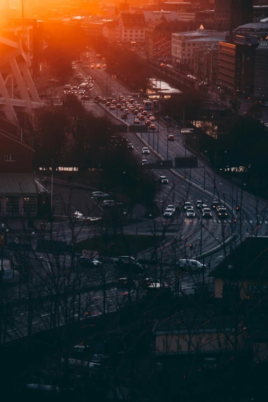 traffic flows down a freeway in a city during the sunset