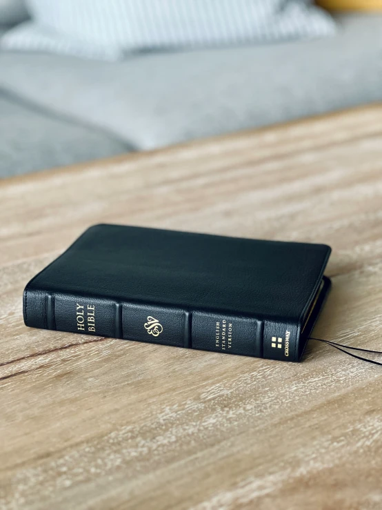 a black book on a wood table