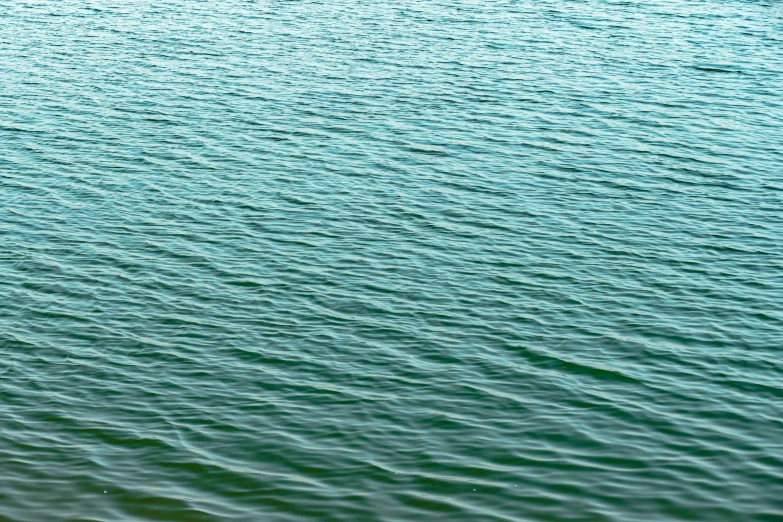 a man in the water with his surfboard under the wave