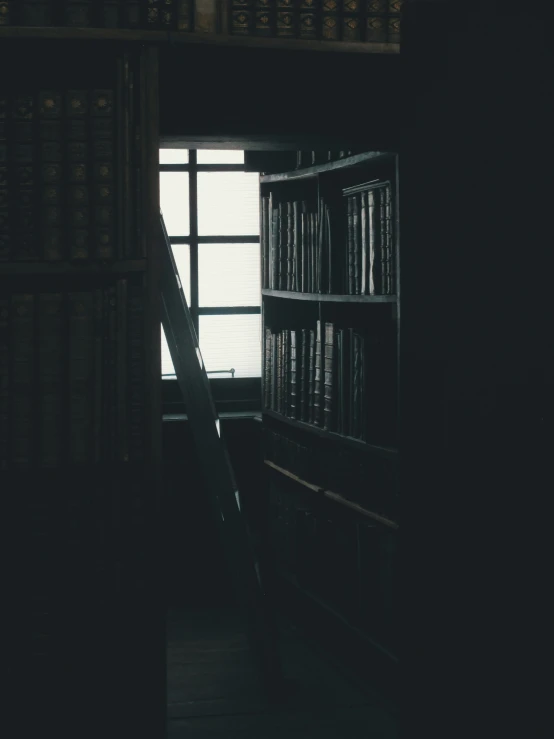 a staircase to an open window with books on it