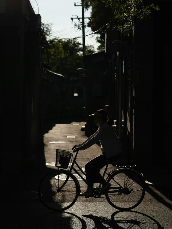 a man riding a bicycle down the middle of a street