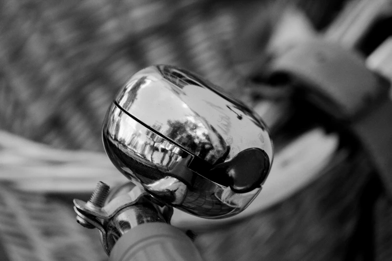 a black and white image of a person holding a bicycle 